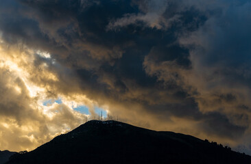 Dramatic rain clouds above the Pichincha volcano at sunset with the arrival of the rainy season in Quito, Andes mountains, Ecuador.