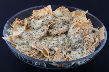 mexican snack nachos with cheese and herbs