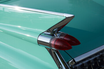 Tail fin on turquoise 1950s automobile