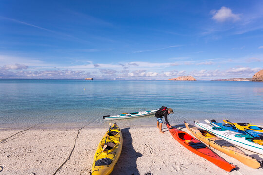 Colorful kayaks lying on the beach, Isla Espiritu, Sea of Cortes
