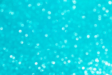 Abstract glitter blurred shiny blue aqua background. Bright sparkling bokeh wallpaper style. Festive Christmas holiday futuristic texture.