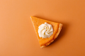 Traditional thanksgiving food on wooden table. Orange delicious homemade pumpkin pie with crust and...