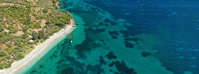 Aerial drone ultra wide panoramic view of tropical paradise sandy beach visited by sailboats and yachts in Caribbean exotic destination island