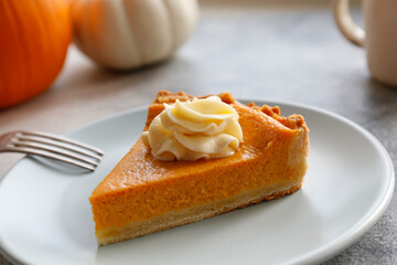 Traditional thanksgiving food on wooden table. Orange delicious homemade pumpkin pie with crust and decorative items. Thanksgiving table setting concept.Top view, close up, copy space, background.