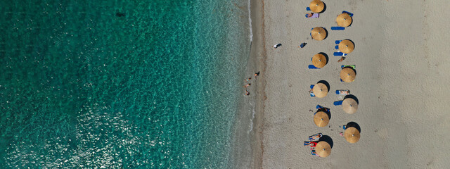 Aerial drone ultra wide panoramic photo of organised with umbrellas and sunbeds turquoise sandy beach in Mediterranean destination island