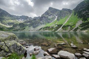 View of Mount Kościelec from the banks of Black Gąsienicowy Lake (Czarny Staw Gąsienicowy) with its clear waters in the foreground, Tatra Mountains, Poland