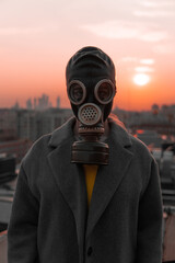 
man in a gas mask on the background of a big city