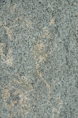 Natural stone grey granite background. Bright hard grey granite rock texture. Grey granite stone background. Grey granite untreated surface.