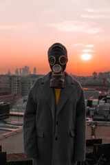 
man in a gas mask on the background of a big city