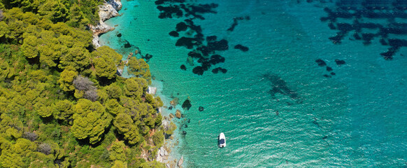 Fototapeta na wymiar Aerial ultra wide panoramic view of tropical paradise rocky bay visited by sailboats and yachts in Caribbean exotic destination island