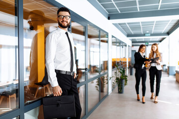 Happy businessman in business clothes in modern office