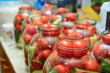 Canned tomato marinated in glass jars at home.
