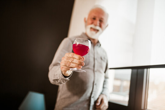 Handsome senior man enjoying perfect wine taste and aroma