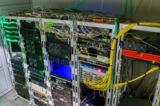 There is a lot of telecommunications equipment in the server room. Powerful computing hardware works in the data center racks. Central technical platform of the Internet provider.