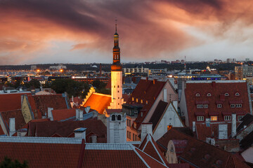 Naklejka premium TALLINN, ESTONIA - OCTOBER, 2, 2019: Evening top view of night Tallinn, Estonia. Old and new buildings. Dramatic sunset sky