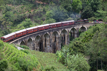 Fototapeta na wymiar Ella Sri Lanka 4.15.2018 the 9 arch Demodara Railway Bridge with train