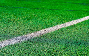 White stripe on green grass, on the football field. Football field with markings.