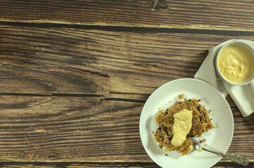 Piece of Apple and blueberry crumble with English cream