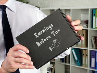 Business concept about Earnings Before Tax with phrase on the piece of paper.