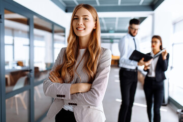 Happy young business woman in office environment