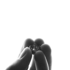 screw-nut in hands on a white background