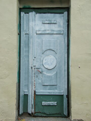 Fototapeta na wymiar Wooden old vintage painted blue door from the street