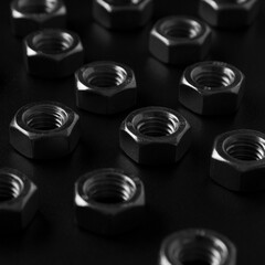 screw-nuts on a dark surface