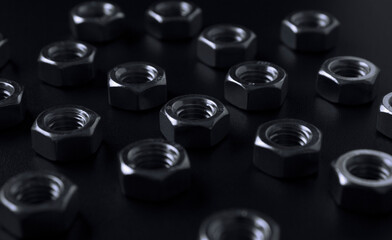 screw-nuts on a dark surface