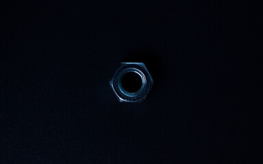 screw-nut on a dark surface