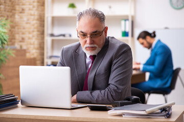 Two male colleagues working in the office