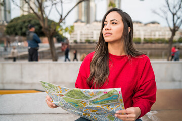 Young traveler woman with a map.