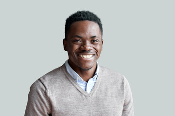 Smiling cheerful young adult african american ethnicity man looking at camera standing at home office background. Happy confident black guy posing for headshot face front close up portrait. - obrazy, fototapety, plakaty
