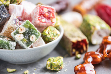 Middle Eastern sweets on blue background. Arab dessert, baklava, halva, rahat lokum, sherbet, nuts, pistachios, dates, raisins, dried apricots, churchkhela, cookies. Top view. Flat lay. Copy space