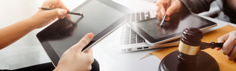 Justice and law concept.Male judge in a courtroom with the gavel, working with, computer and...