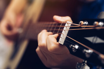 Close-up hands and tuning of the guitar player