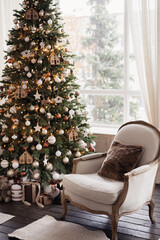 Christmas tree and chair, living room decorated for Christmas. High quality photo