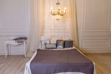 Stylish loft bedroom interior. Spacious design apartment in baroque style with light walls elegant...