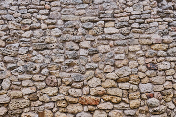 Texture of a very ancient stone wall