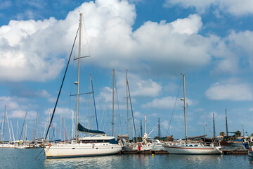 Obraz premium large and small sailboats in the harbor of the Greek city of Rethymno against the backdrop of a beautiful cloudy sky