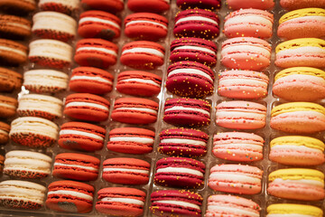 macaroons in a row in different colors on the counter