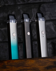 Vaping pen, vape devices, mods for electronic cigarette or e cigarette, e cig, on a wooden...