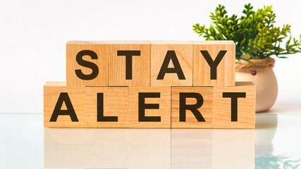 stay alert word written on wood block. Faqs text on table, concept