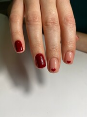 Red nails and a heart on the nails
