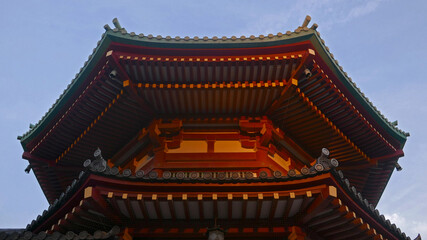 Fototapeta premium View from below of a beautiful ancient buddhist temple in japan predominating de color red