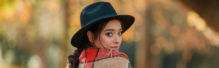 Autumn portrait of a beautiful young woman in the park