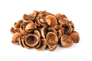 Pile of hazelnut shells isolated on white background. Healthy vegetarian eating, antioxidant and protein source. Food waste and peelings.