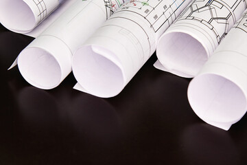 Architectural project, drawings on a dark background. Rolls of project drawings