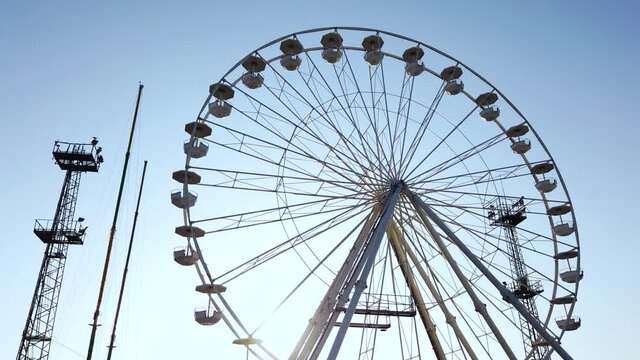 Layout or template for video editing. Moving towards ferris wheel on a background of blue sky. Stabilized with gimbal