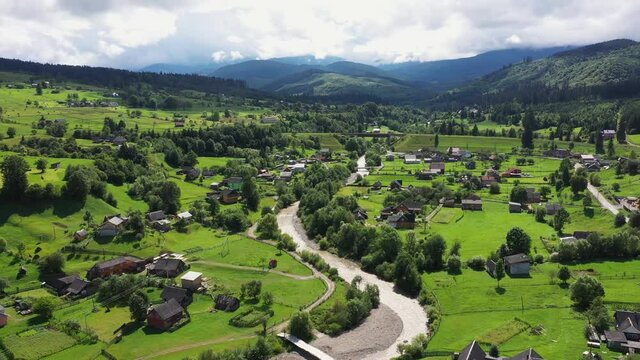 Mountains village landscape with River and Beautiful vintage wooden houses aerial view.