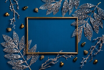 Christmas composition. Frame with golden branches on blue background. Christmas, winter, new year...